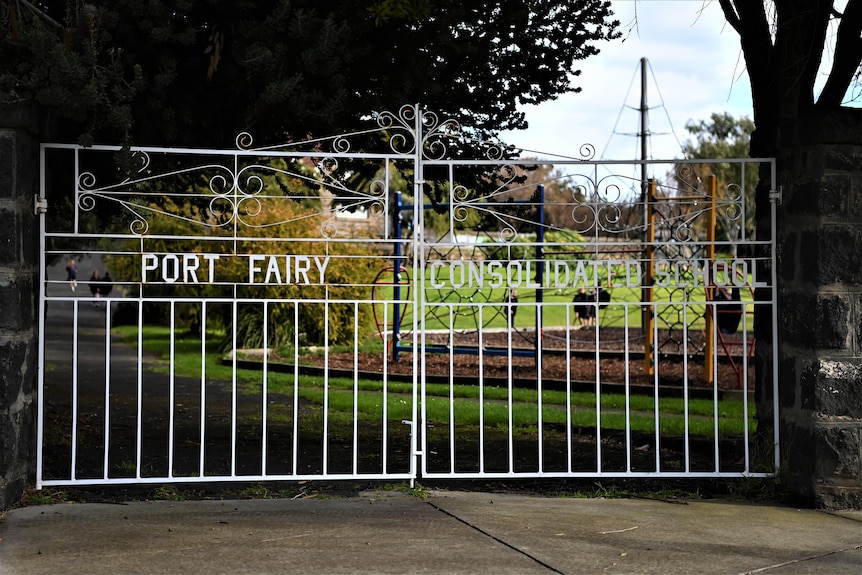 An old wrought-iron school gate reading Port Fairy Consolidated School.