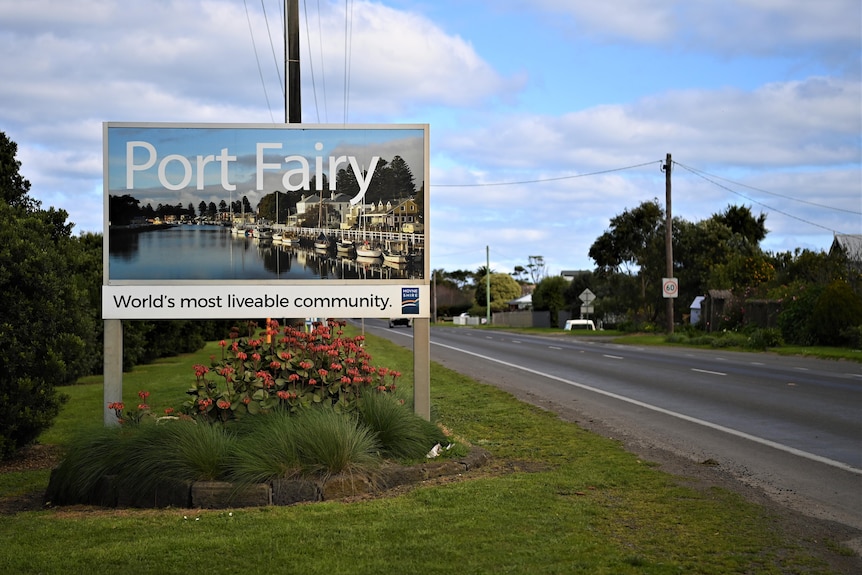A sign by a roadside saying "Port Fairy - world's most liveable community".